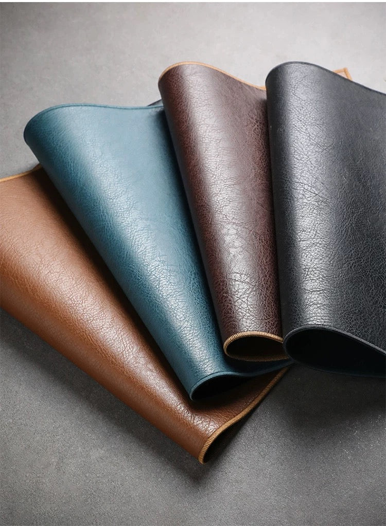 Four leather samples in different colors on a gray background