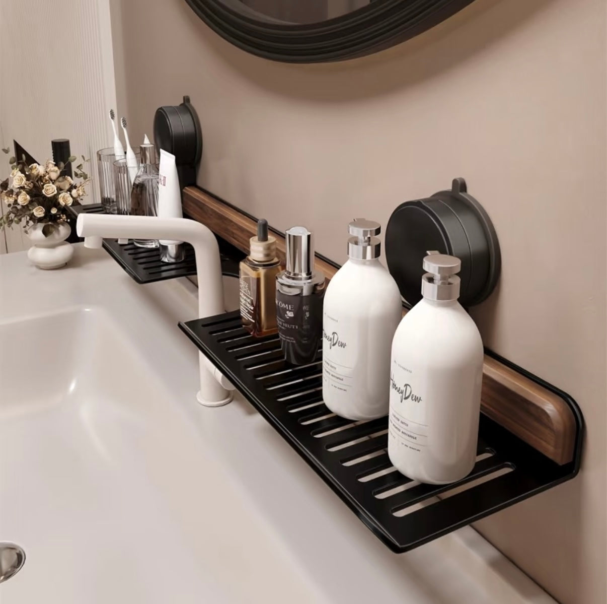 Bathroom counter with black tray holding skincare bottles, white sink, and mirror.
