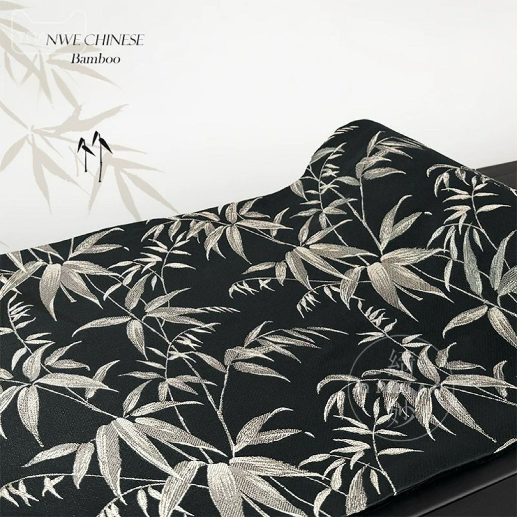 Fabric with silver bamboo leaf pattern on black background, brand 'NWE CHINESE' visible.