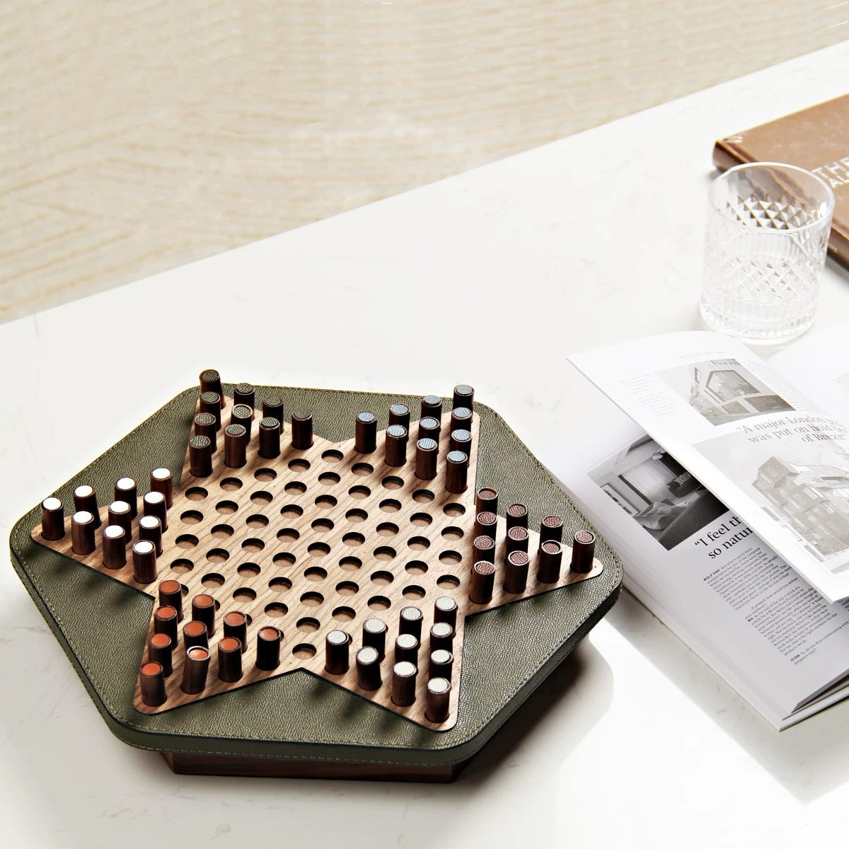 Hexagonal wooden puzzle on a table with a magazine