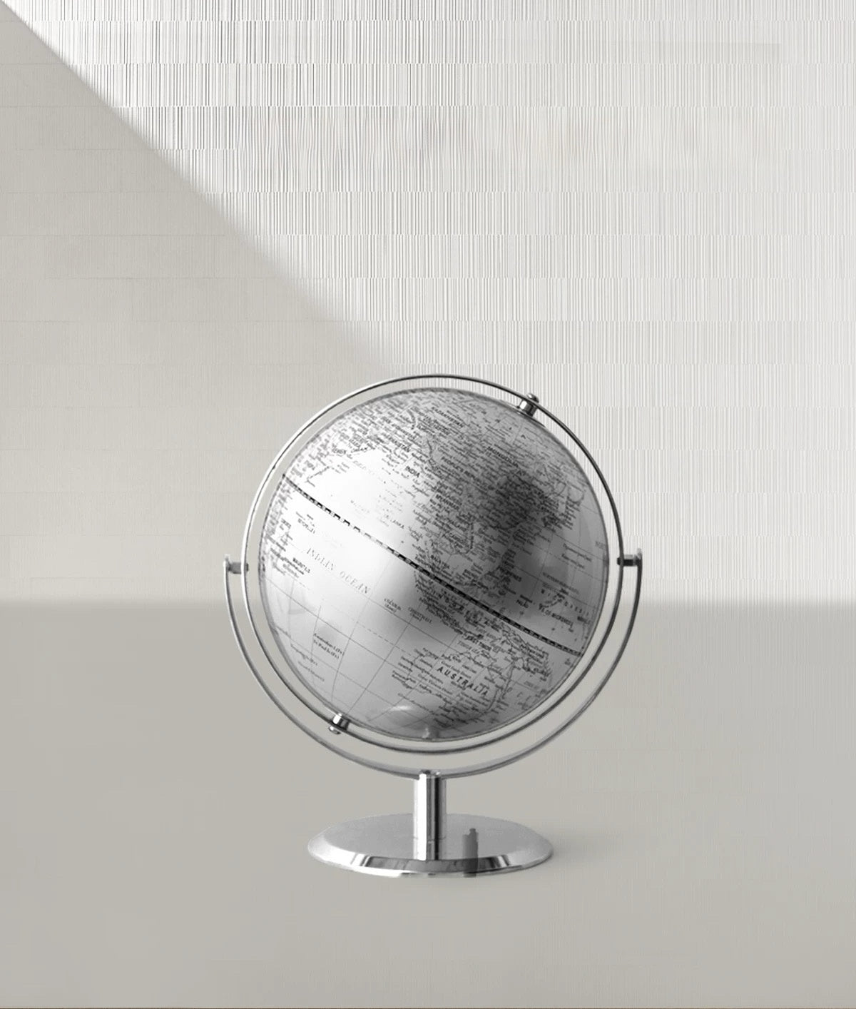 Globe on a stand against a light gray background