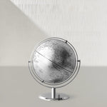 Globe on a stand against a light gray background