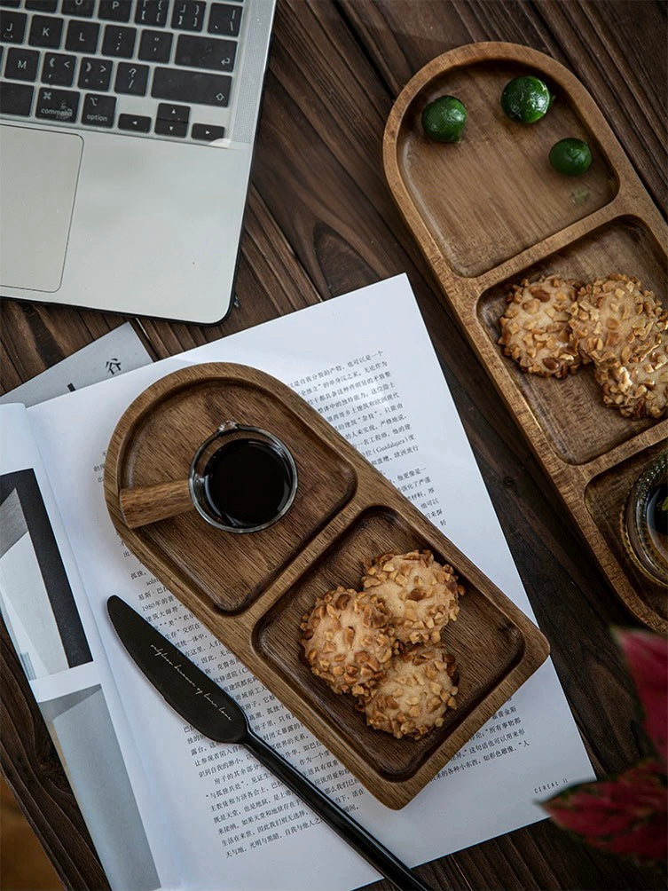 Wooden tray with cookies and a cup of coffee on a desk next to a laptop