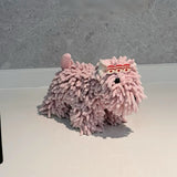 Pink fuzzy slippers on a white surface with a gray background
