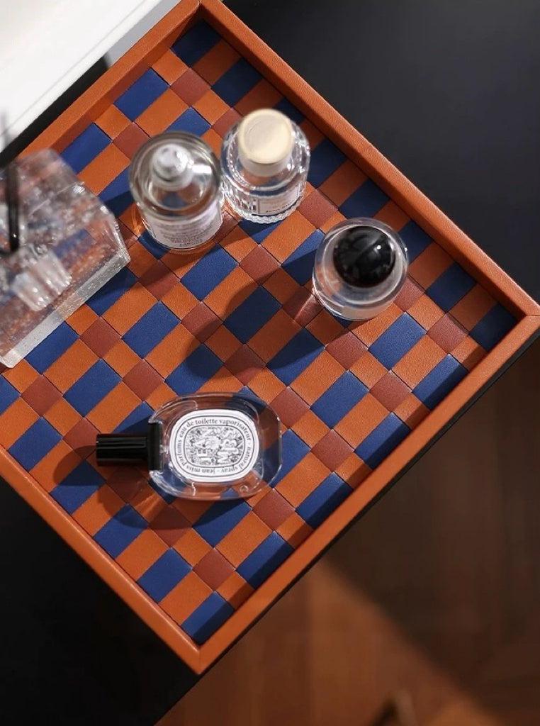 Set of nail polish bottles on a checkered wooden tray