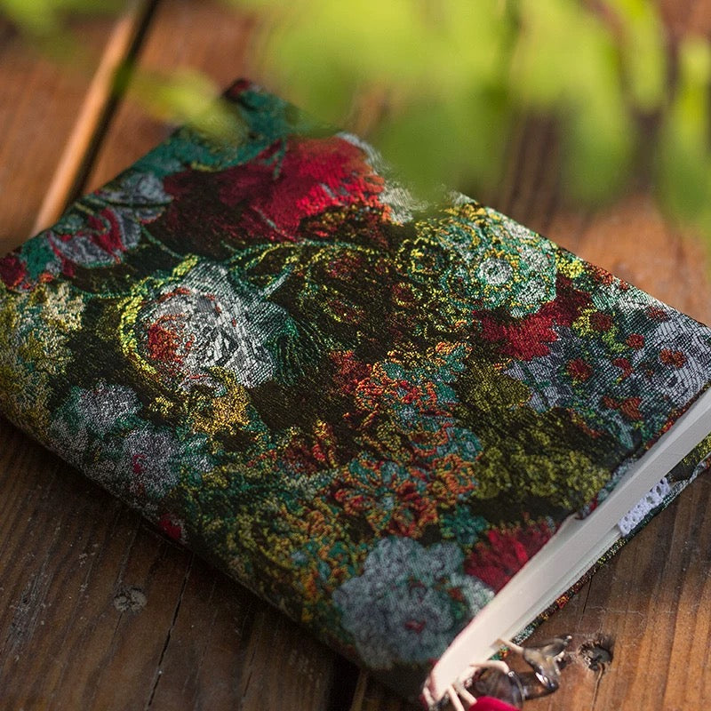Decorative notebook with floral pattern on a wooden surface