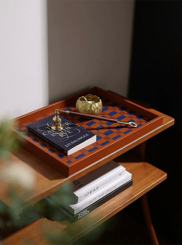 Wooden tray with decorative items on a wooden surface