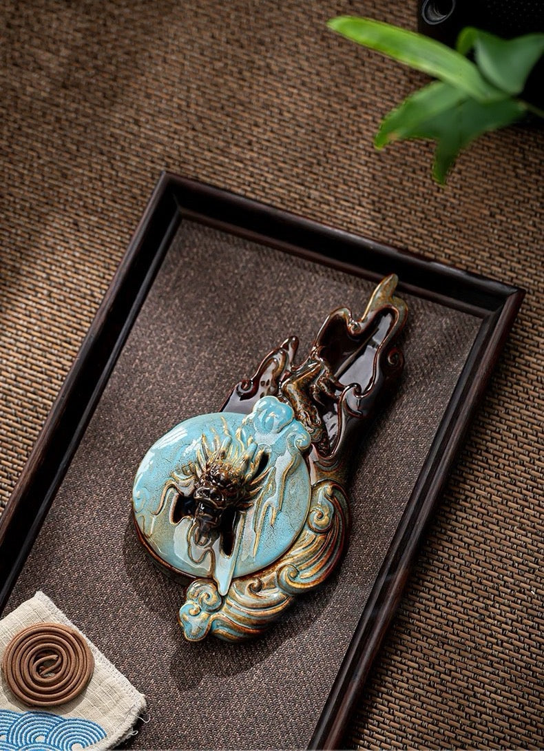 Decorative keychain with intricate design on a brown textured surface