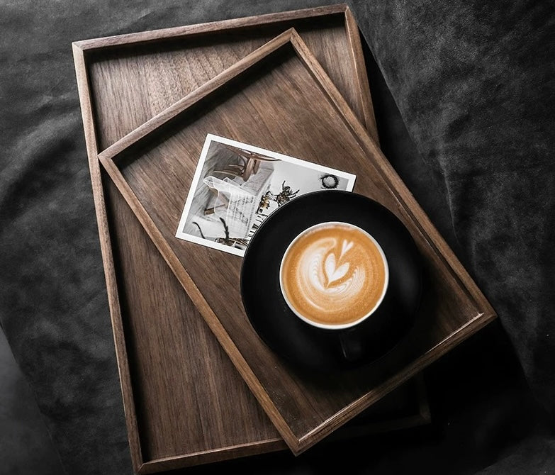 Wooden tray with a cup of coffee and a photo on a dark surface