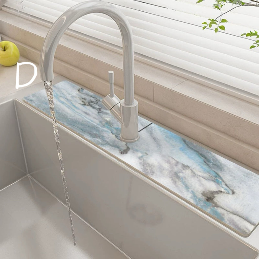 Kitchen sink with marble-like backsplash and modern faucet