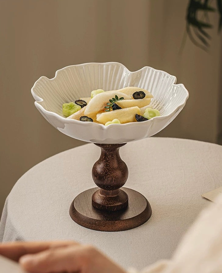 Decorative white bowl with a brown base on a table