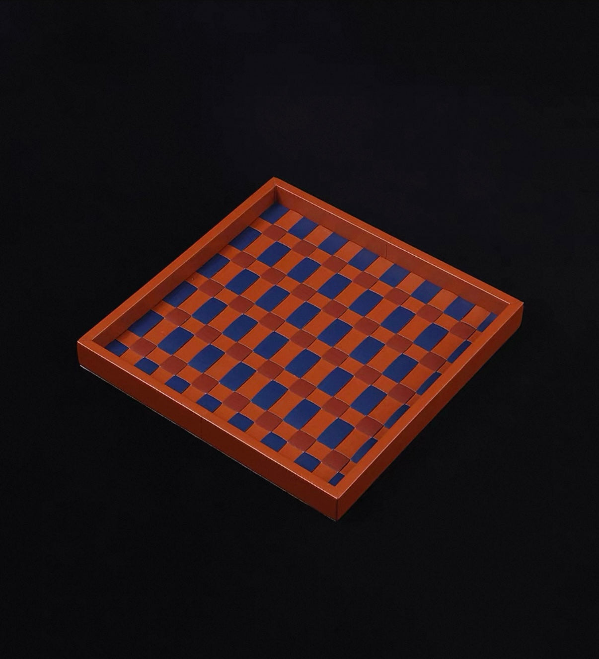 Wooden checkers board with alternating brown and blue squares on a black background