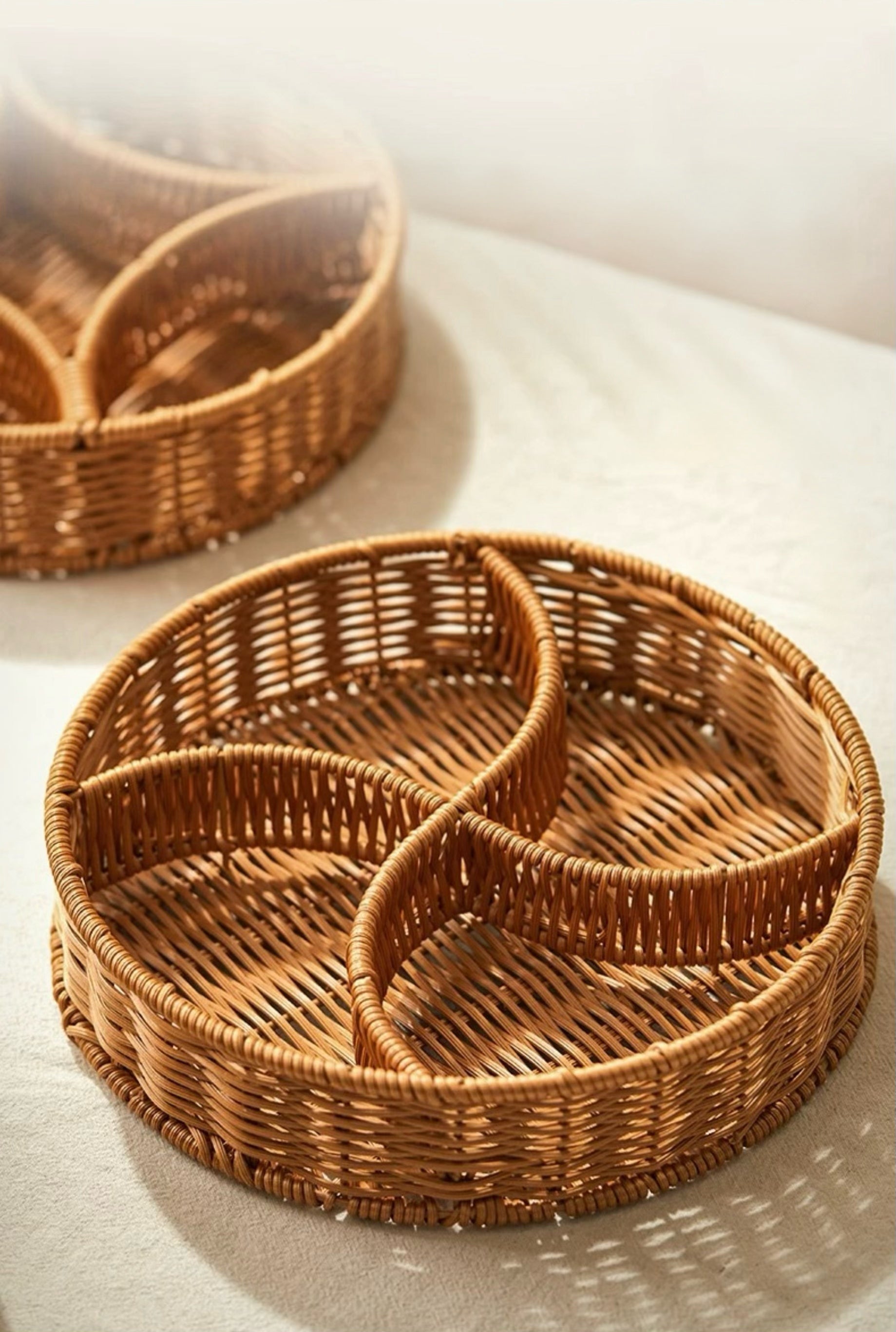 Two woven baskets on a light surface with soft shadows