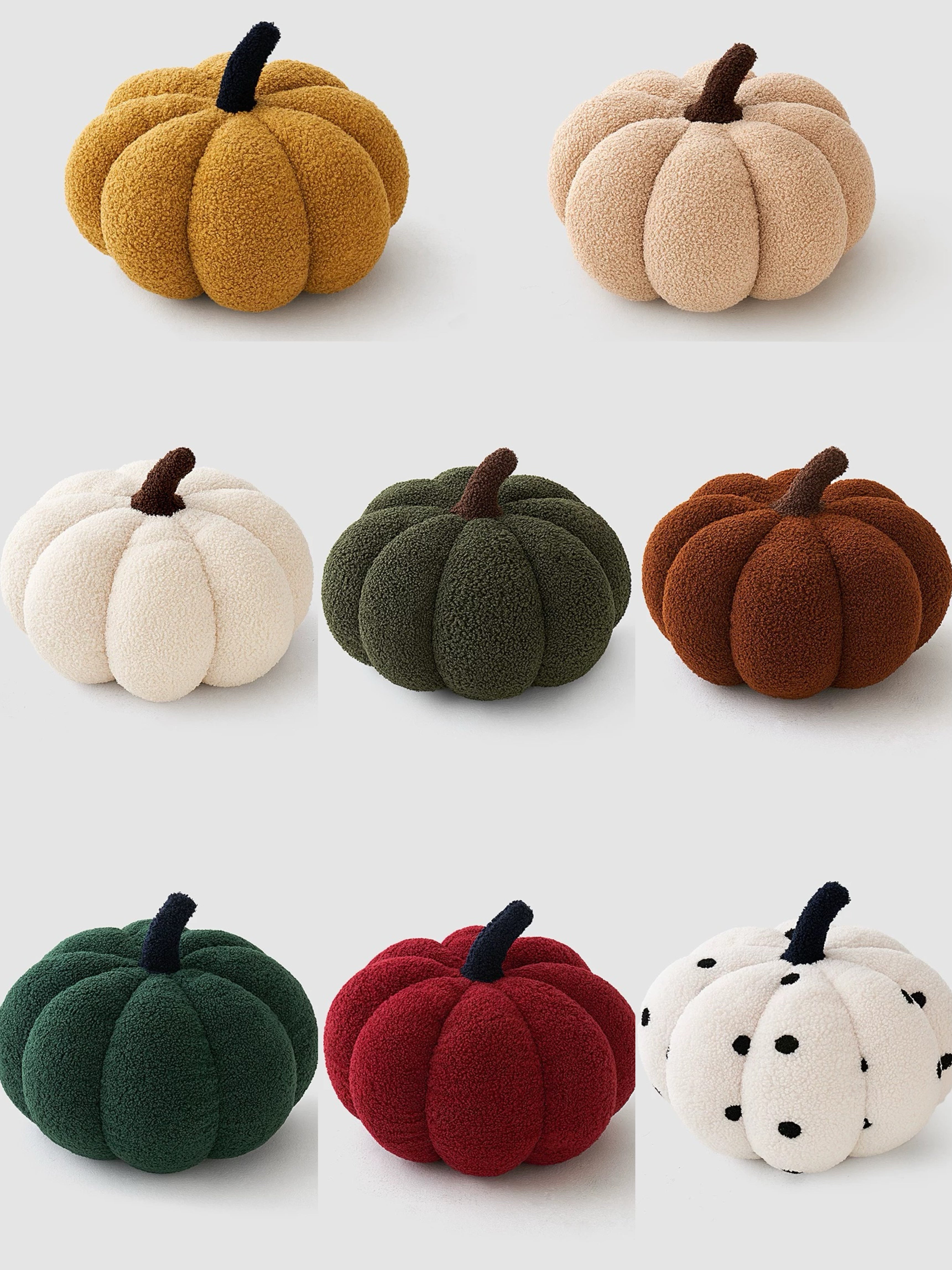 Set of colorful pumpkin-shaped plush toys on a white background