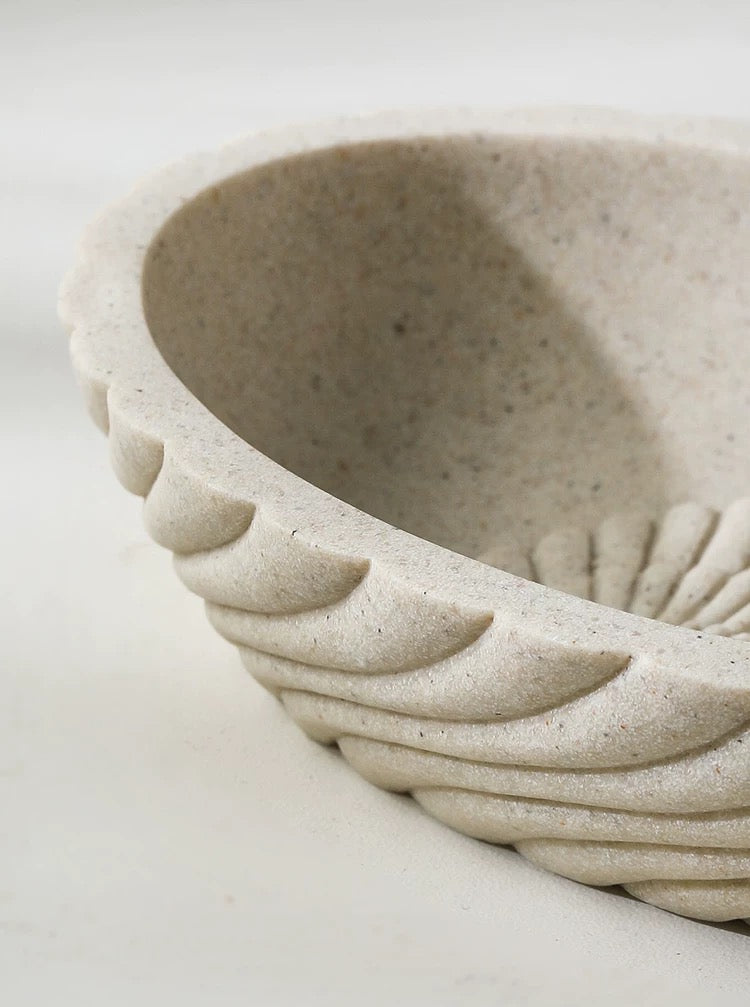 Close-up of a textured ceramic bowl on a white background