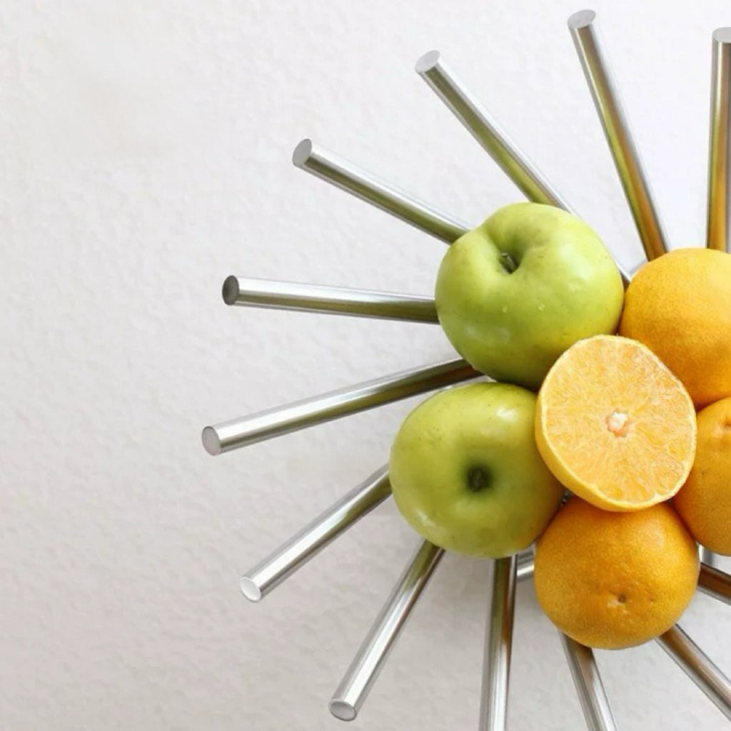 Fruit bowl with apples and oranges on a white background
