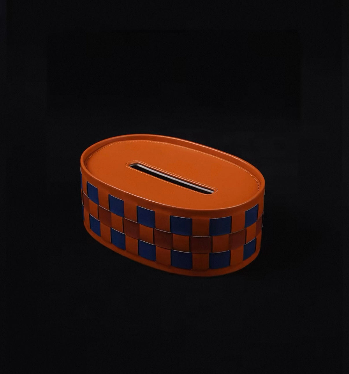 Brown woven tissue box with a checkered pattern on a black background