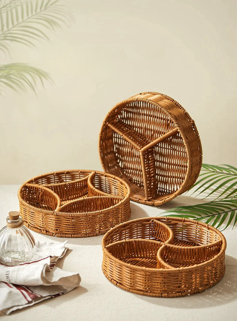 Set of wicker trays with compartments on a light surface with leafy background