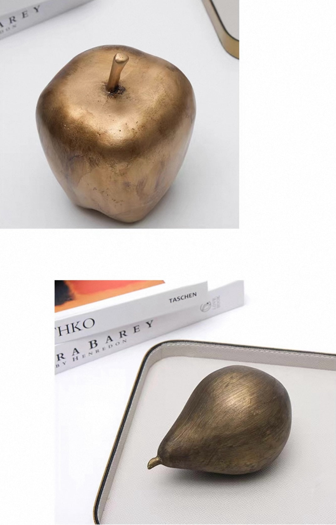 Bronze apple and pear on a white surface with books in the background