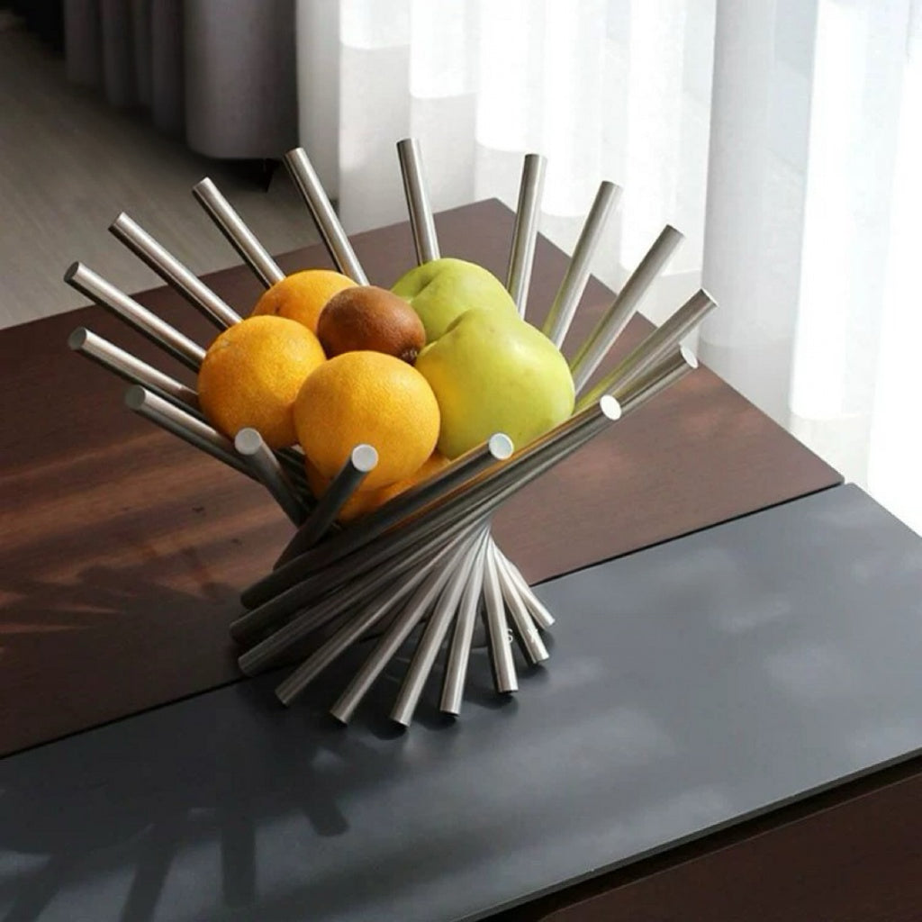 Modern metal fruit bowl with fruits on a table