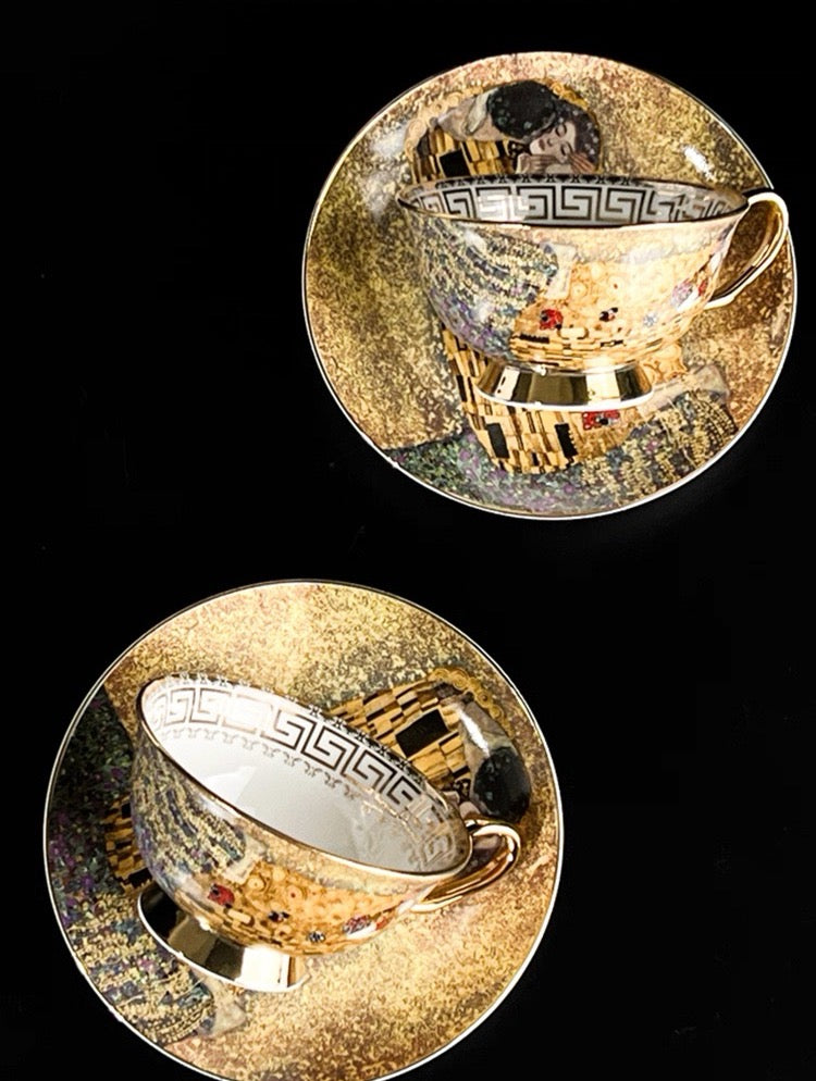 Two gold and silver decorative plates with intricate designs on a black background