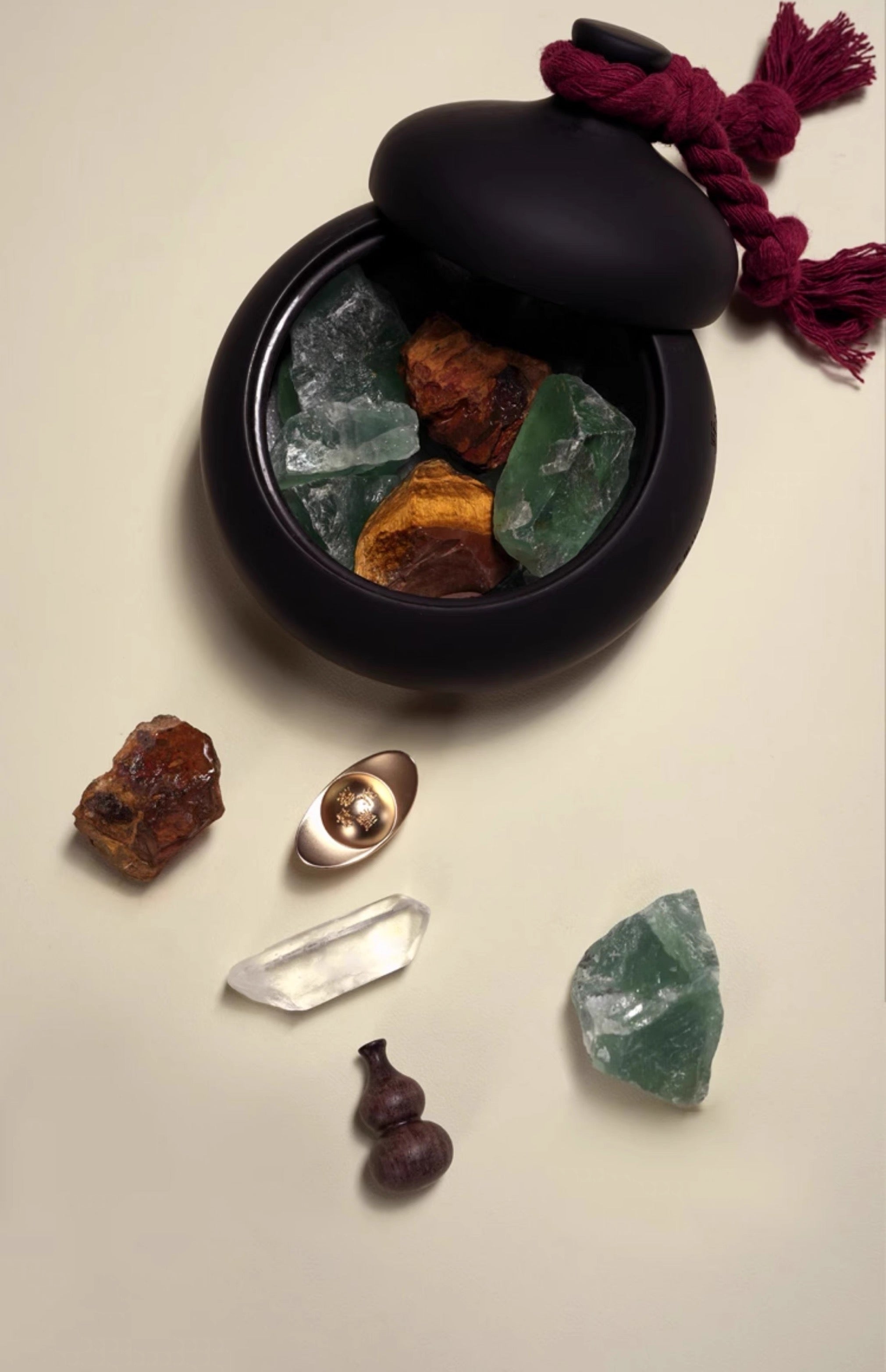 Black container with crystals on a beige background