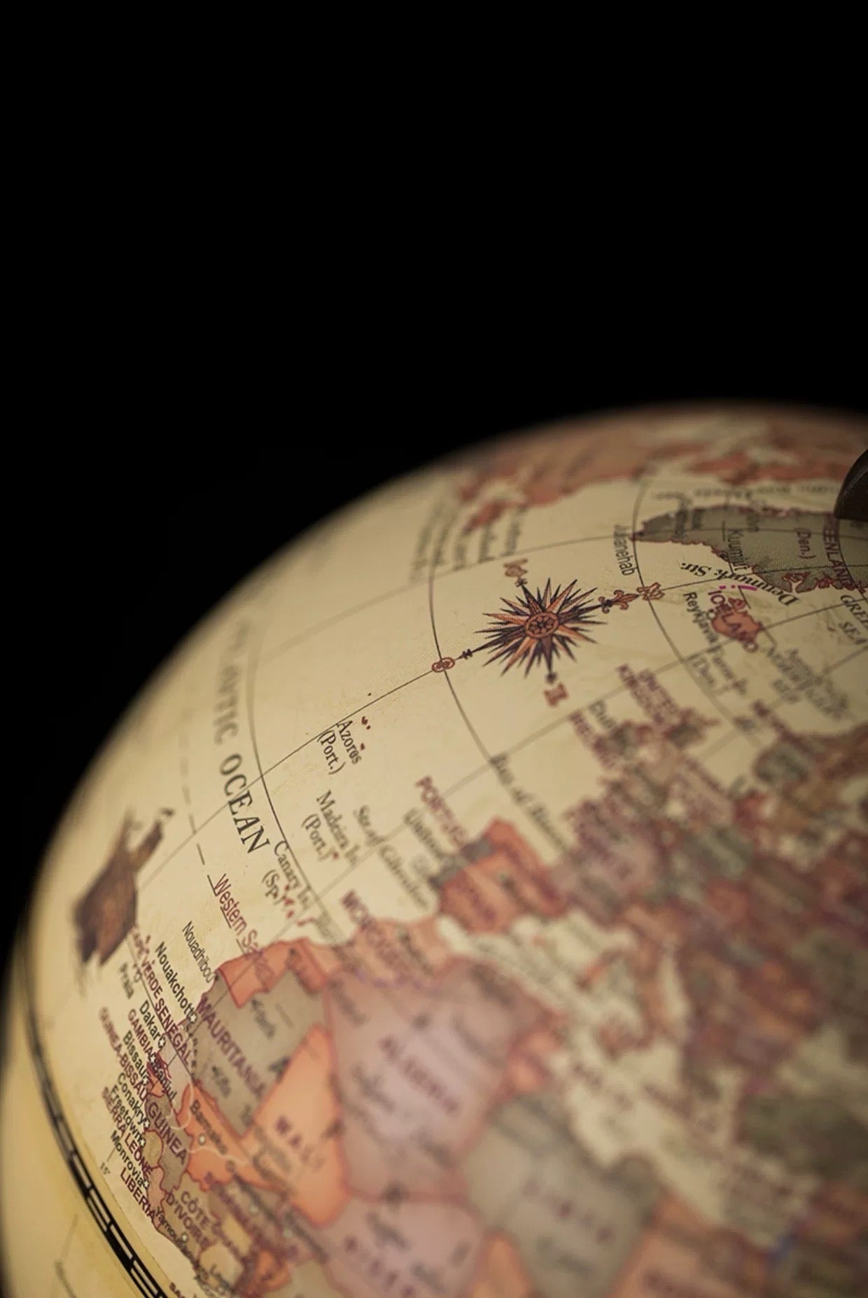 Close-up of a vintage-style globe with detailed map and compass rose.