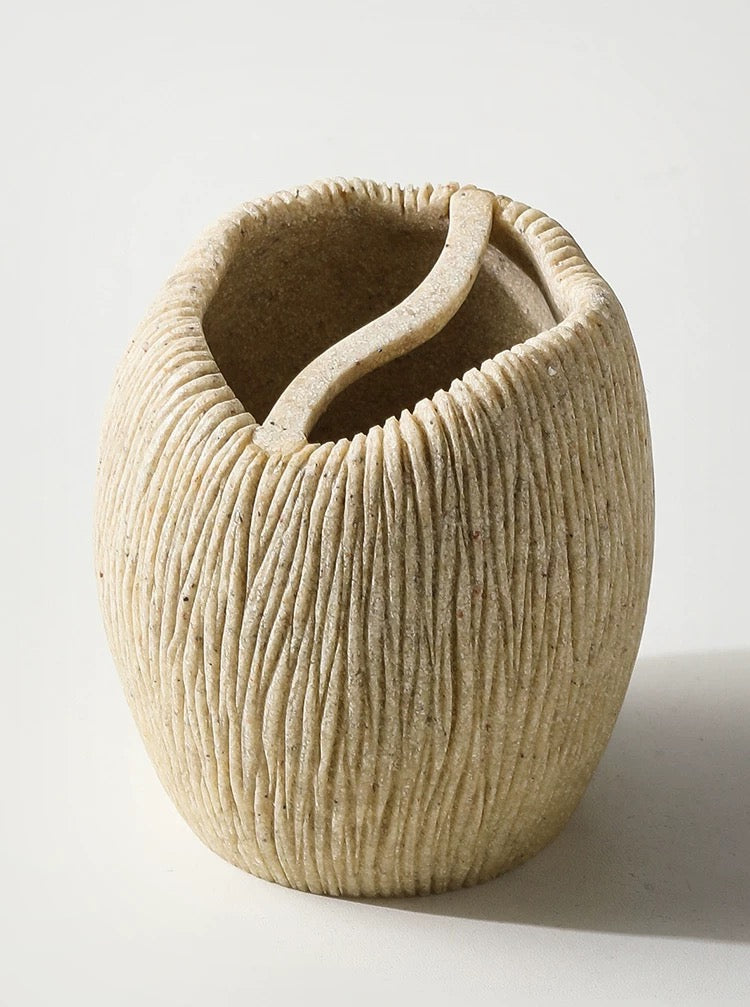 Textured ceramic vase on a white background
