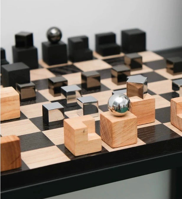 Wooden and metallic chess pieces on a chessboard