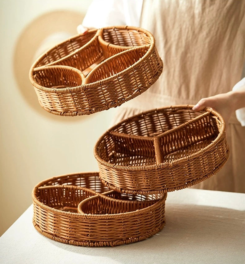 Three woven baskets of different sizes on a light surface with a neutral background