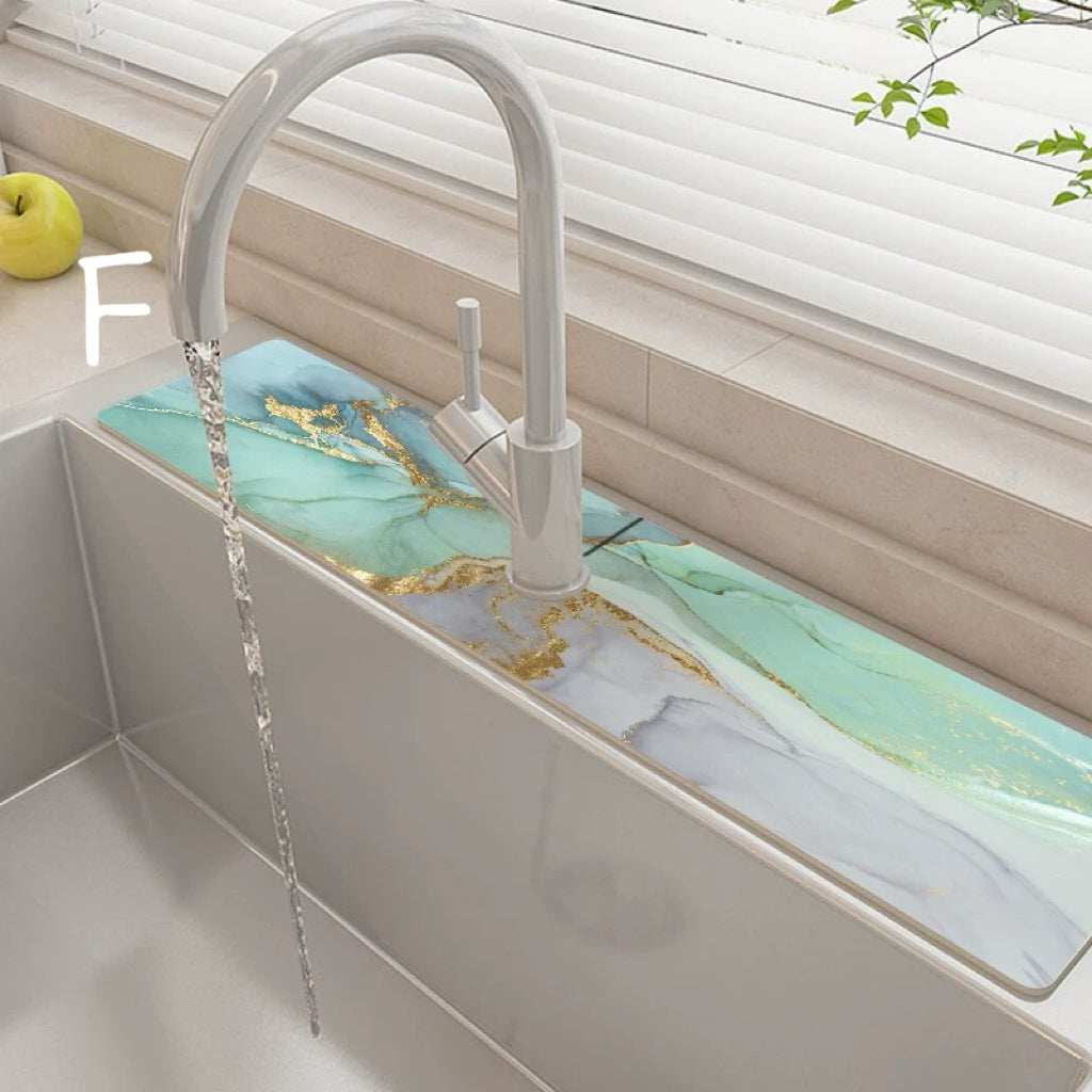 Modern kitchen sink with marble-like green countertop and white faucet.