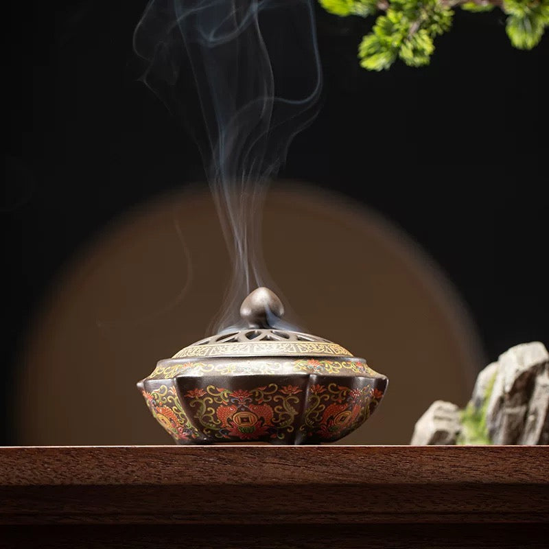 Decorative incense burner with smoke on a wooden surface