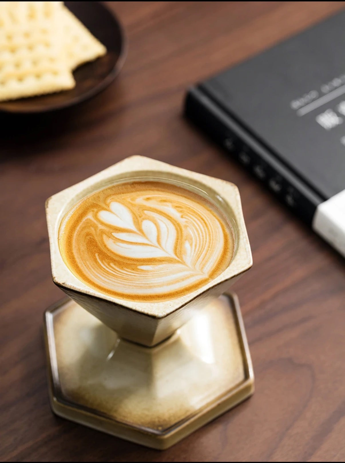 Hexagonal metal stand with a cappuccino on a wooden surface