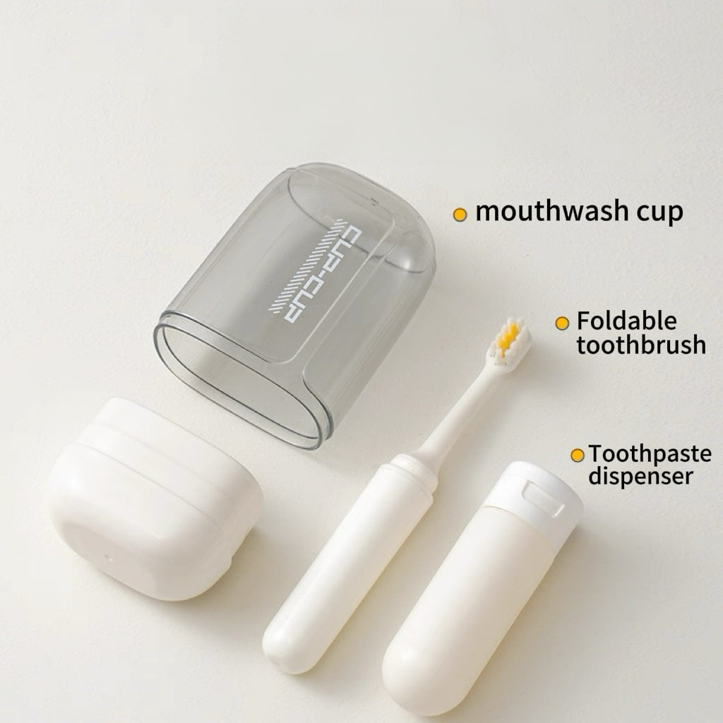 Set of travel dental hygiene products including a mouthwash cup, foldable toothbrush, and toothpaste dispenser on a white background.