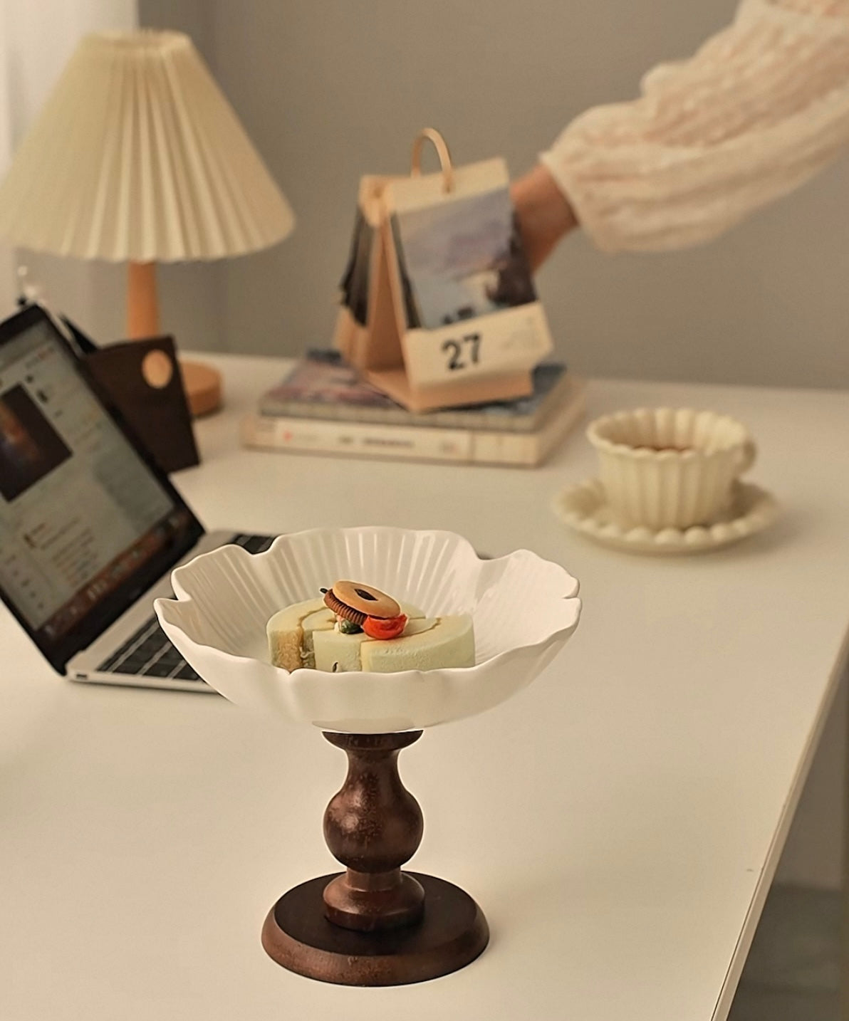 Decorative bowl with snacks on a desk next to a laptop