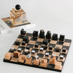 Wooden chessboard with black and brown pieces on a white surface