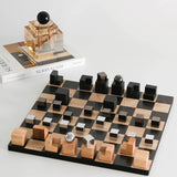 Wooden chessboard with black and brown pieces on a white surface