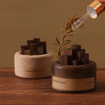 Wooden diffusers with 'HomeFlower' branding on a wooden surface.