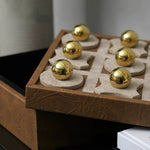 Board game with gold pieces on a wooden board