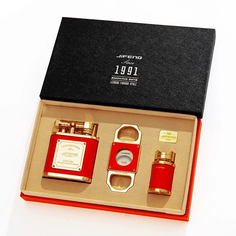 Cigar accessories set with red and gold items in a black Jifeng box on a white background