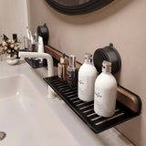 Bathroom counter with black tray holding skincare bottles, white sink, and mirror.