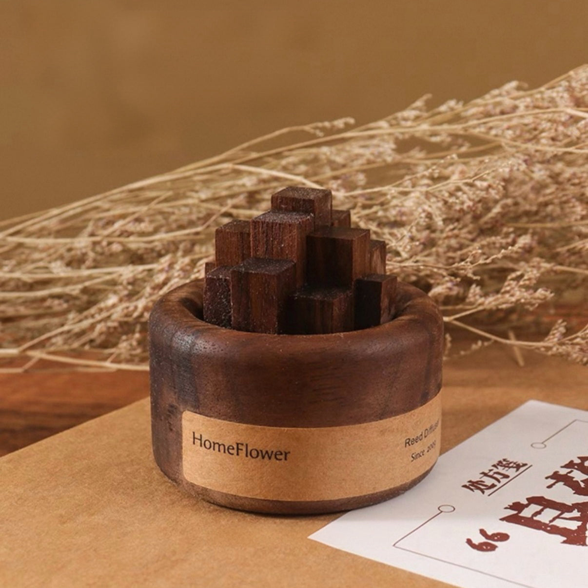 Wooden incense holder with 'HomeFlower' branding on a brown surface with dried plants in the background.