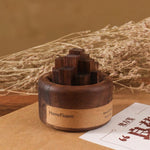 Wooden incense holder with 'HomeFlower' branding on a brown surface with dried plants in the background.