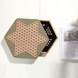Hexagonal wooden puzzle with star design on a white surface next to a magazine.