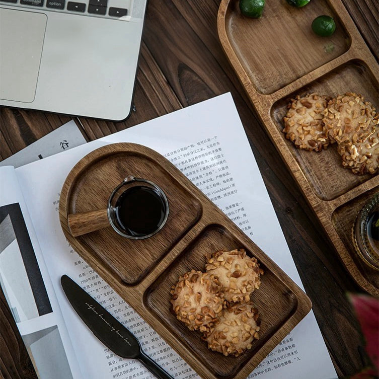 Wooden tray with cookies and a cup of coffee on a desk next to a laptop