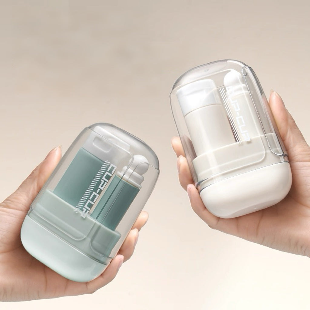 Two hands holding small cylindrical containers, one green and one white, against a beige background.