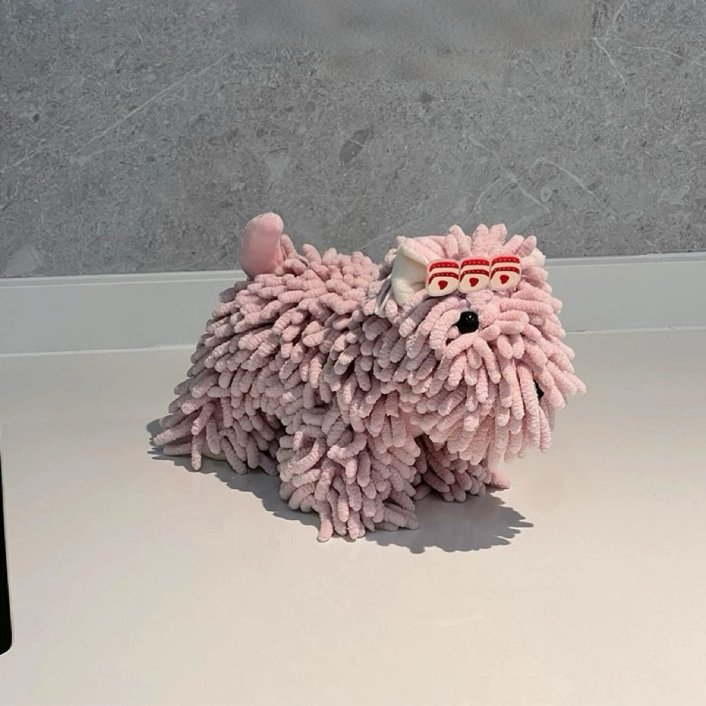 Pink fuzzy slippers on a white surface with a gray background