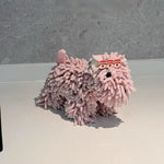 Pink fuzzy slippers on a white surface with a gray background