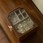 Wooden box with glass stones on a wooden surface