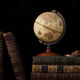 Vintage-style globe on a stack of old books with a dark background